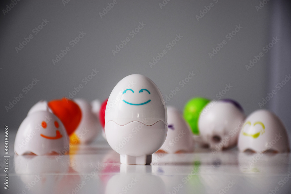 Funny emotional eggs on white table