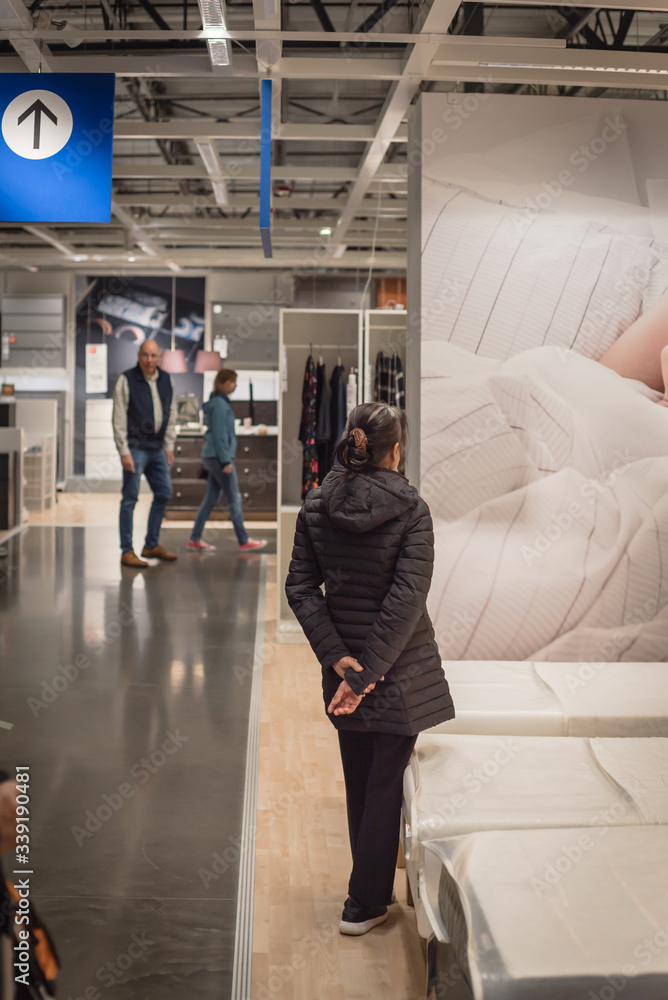 Fototapeta premium Rear view Asian customers shopping at furniture and home furnishing store in Dallas, Texas, USA