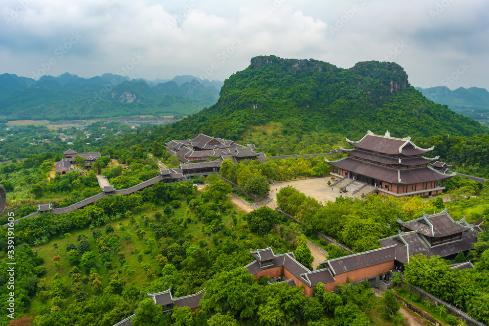 Bai Dinh Temple Spiritual and Cultural Complex, is the biggest Buddhism Temple in South East Asi. It is located in Ninh Binh Province. Vietnamese foggy, hilly countryside is visible in the background.