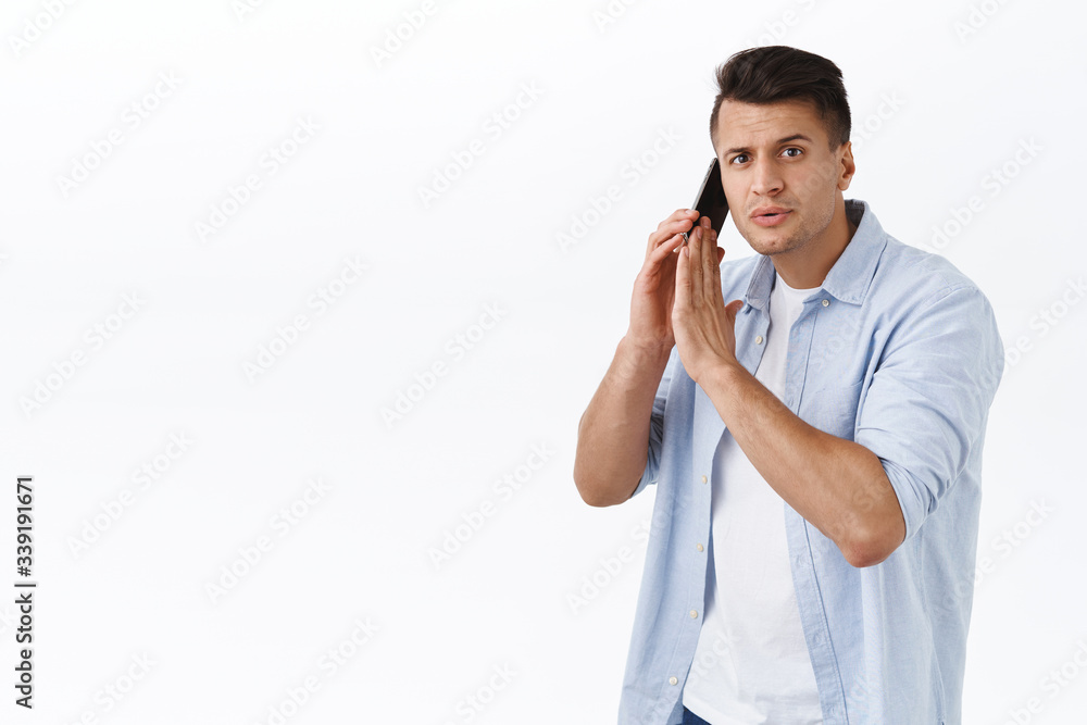 Sorry I busy talking. Portrait of handsome adult man have phone conversation, close dynamic with palm as someone ask him question, ask person to wait sec, have important call, white background Sorry I busy talking. Portrait of handsome adult man have phone conversation, close dynamic with palm as someone ask him question, ask person to wait sec, have important call, white background
