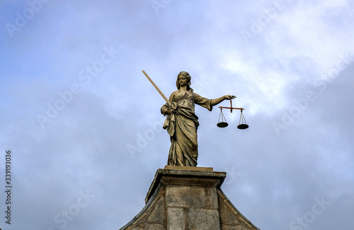Statue of justice. Sky background. 