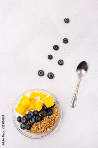 Bowls of Mueslie with Yogurt and Berry Mango Healthy Breakfast Diet Food Top View Flat Lay Vertical photo