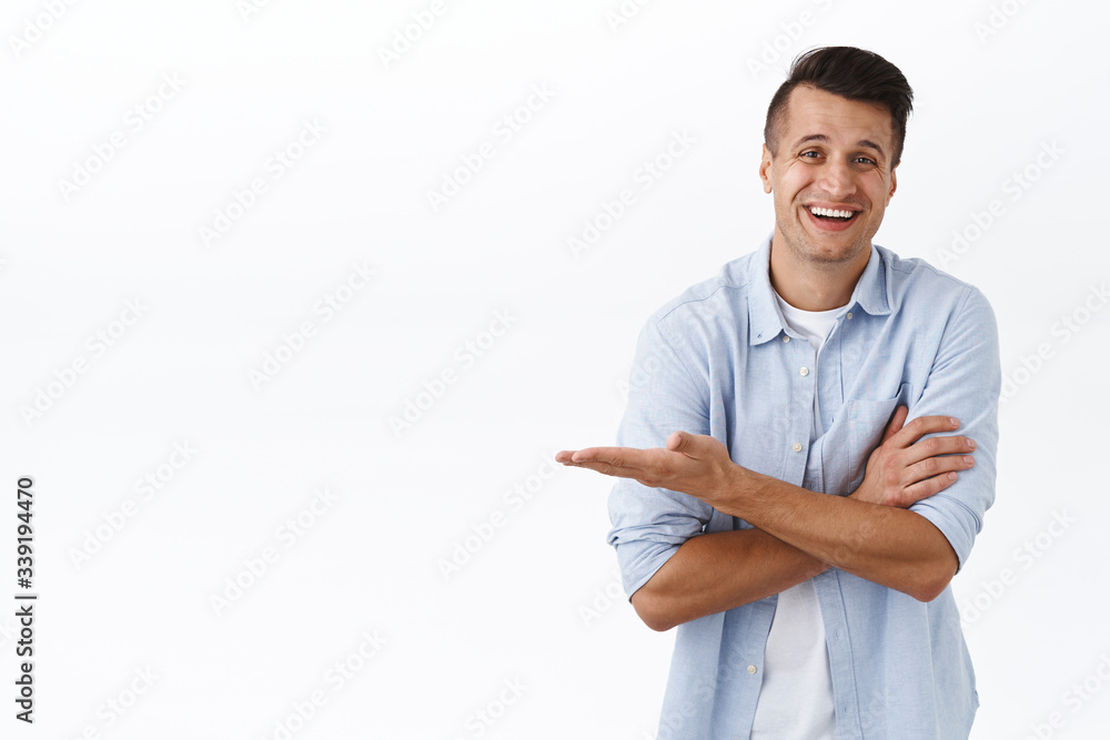 Portrait of handsome adult man showing product promo, pointing hand left white empty space, presenting advertisement, recommend company service, online shop or product, smiling pleased Portrait of handsome adult man showing product promo, pointing hand left white empty space, presenting advertisement, recommend company service, online shop or product, smiling pleased