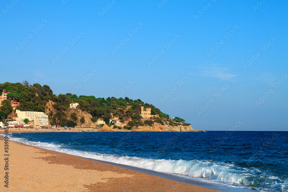 Waves on the beach of Lloret de Mar in the summer. Catalonia, Spain.