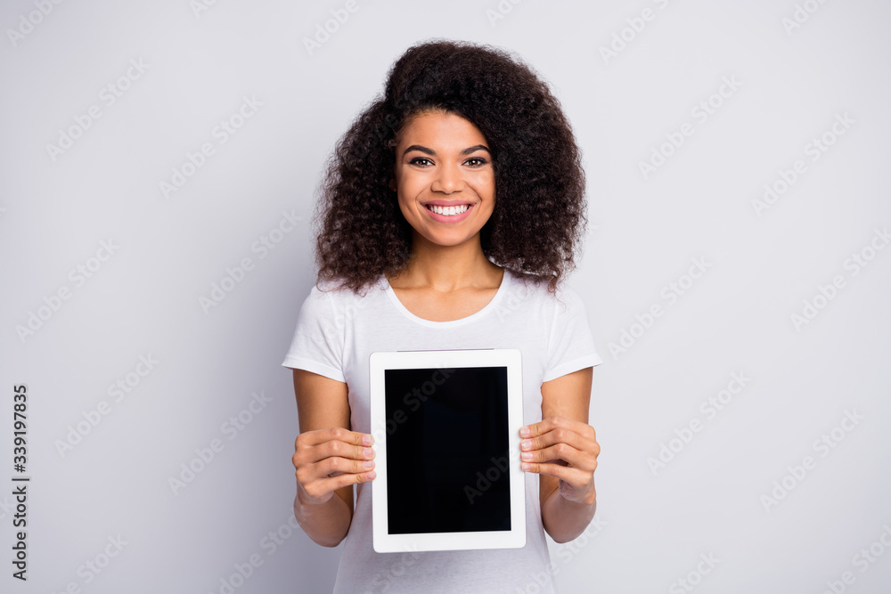 Portrait of her she nice attractive lovely pretty cheerful cheery wavy-haired girl holding in hands showing new digital gadget e-book isolated over light white pastel color background Portrait of her she nice attractive lovely pretty cheerful cheery wavy-haired girl holding in hands showing new digital gadget e-book isolated over light white pastel color background