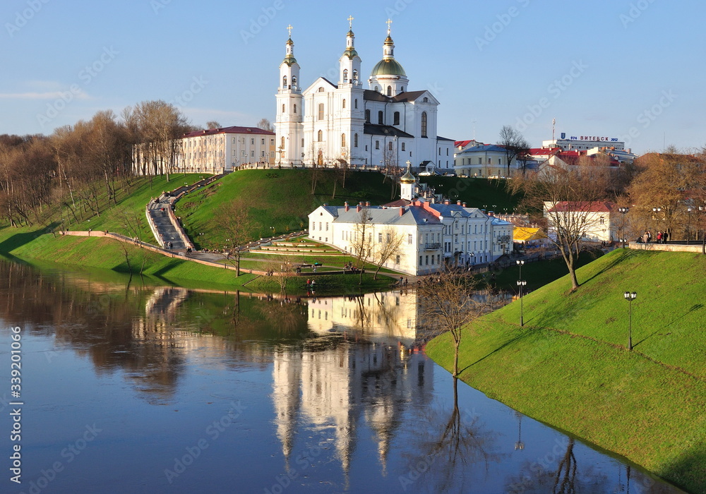 Orthodox Church in spring on the high bank of the river under a clean and clear sky