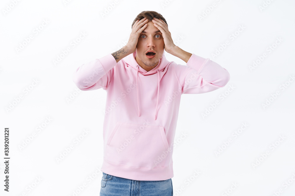 Portrait of shocked, startled handsome blond man, gasping hold hands on head startled over terrible news, panicking, feel alarmed or anxious, standing white background bothered Portrait of shocked, startled handsome blond man, gasping hold hands on head startled over terrible news, panicking, feel alarmed or anxious, standing white background bothered