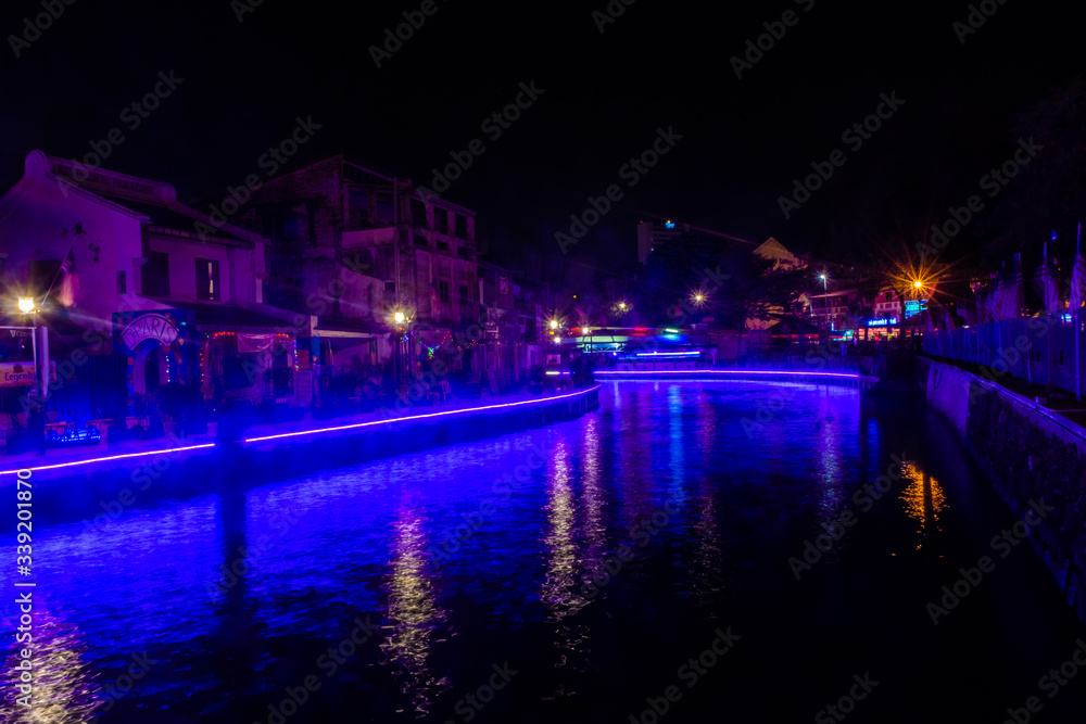 MALACCA, MALAYSIA, SEPTEMBER 29 2019: Blue lights illuminating the canal of Malacca by night