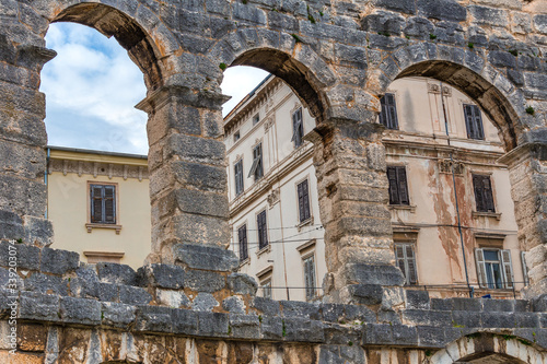 The Roman Arena with a surrounding architecture in Pula town, Croatia, Europe.