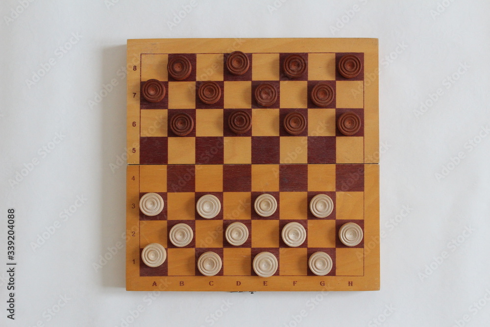 Checkers on a checkerboard on a light background Checkers on a checkerboard on a light background