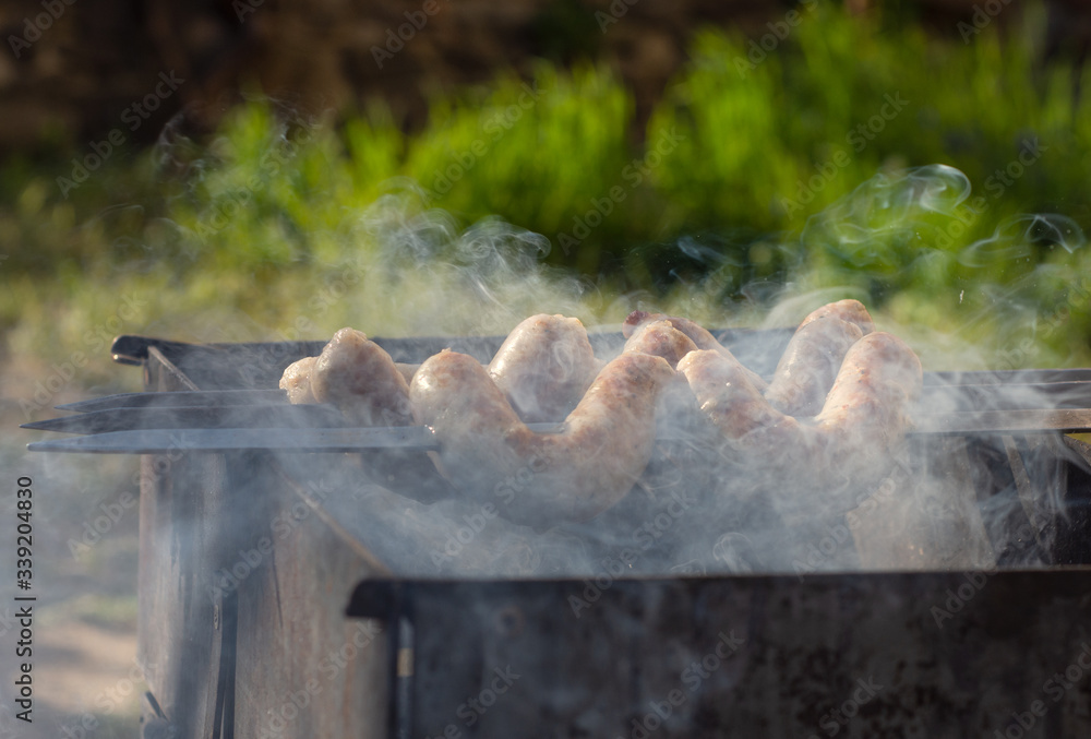 Grilled sausages on grill with smoke Grilled sausages on grill with smoke
