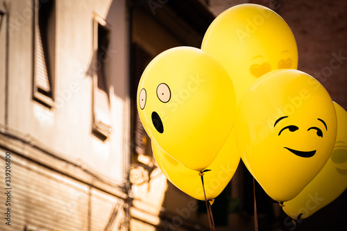 Obraz na płótnie Yellow Emoji balloons floating at a street party in Senigallia, Le Marche, Italy w salonie