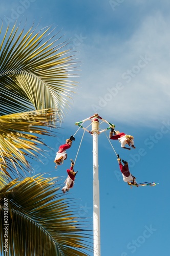 Low angle shot of Voladorez dance ritual with the flyers executing the descending flight photo