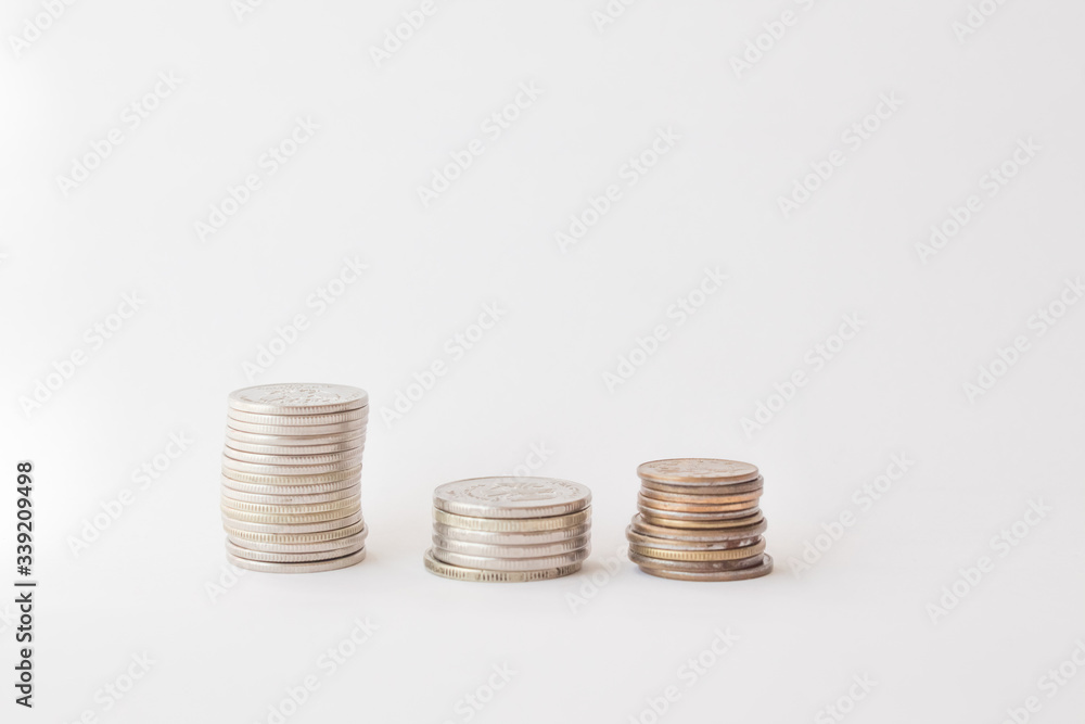 Three piles of coins on a white background. concept of money, finance, business. Berabota increase. copy space for text Three piles of coins on a white background. concept of money, finance, business. Berabota increase. copy space for text