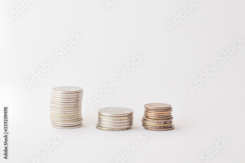  Three piles of coins on a white background. concept of money, finance, business. Berabota increase. copy space for text