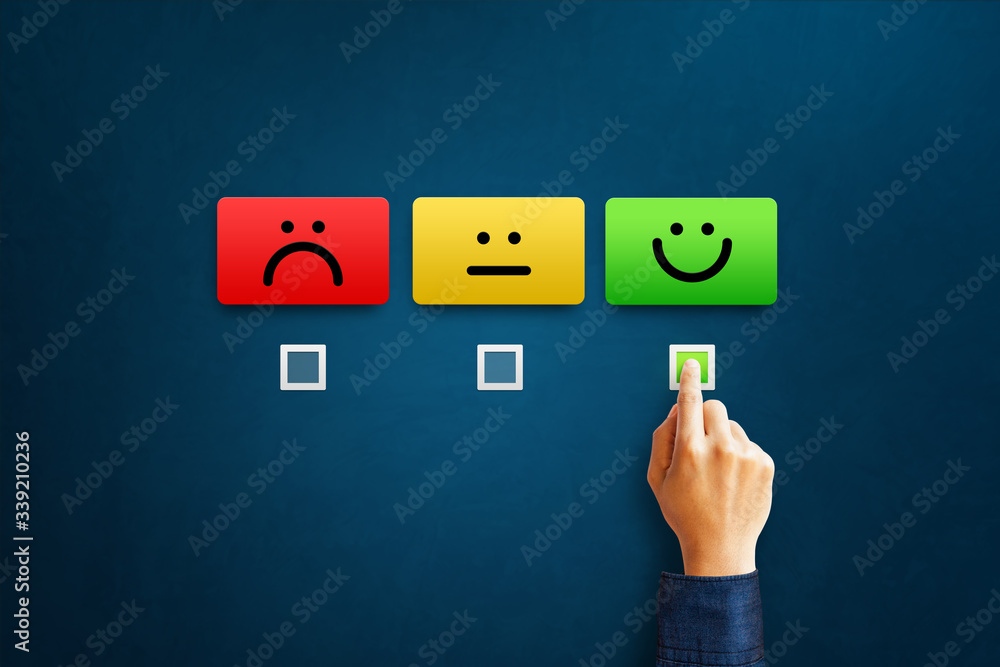 Hand of client show a feedback with smiley face card. Service rating, satisfaction concept Hand of client show a feedback with smiley face card. Service rating, satisfaction concept