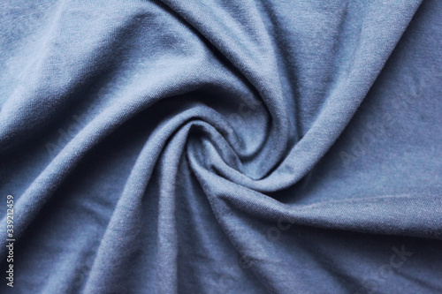 Wavy blue cloth texture, worn messy fabric pattern background. Drapery sheet messy light azure blue colour, soft linen detailed sheets close up top view
