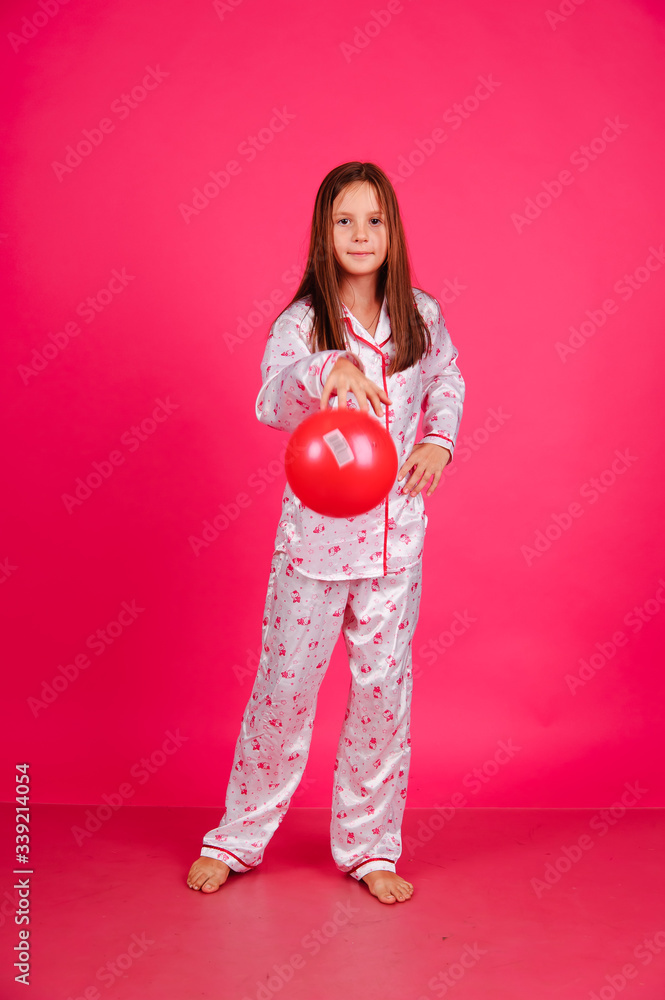 girl in pajamas with balloons on a pink background in the studio girl in pajamas with balloons on a pink background in the studio