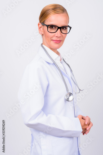 Profile view of blonde woman doctor looking at camera