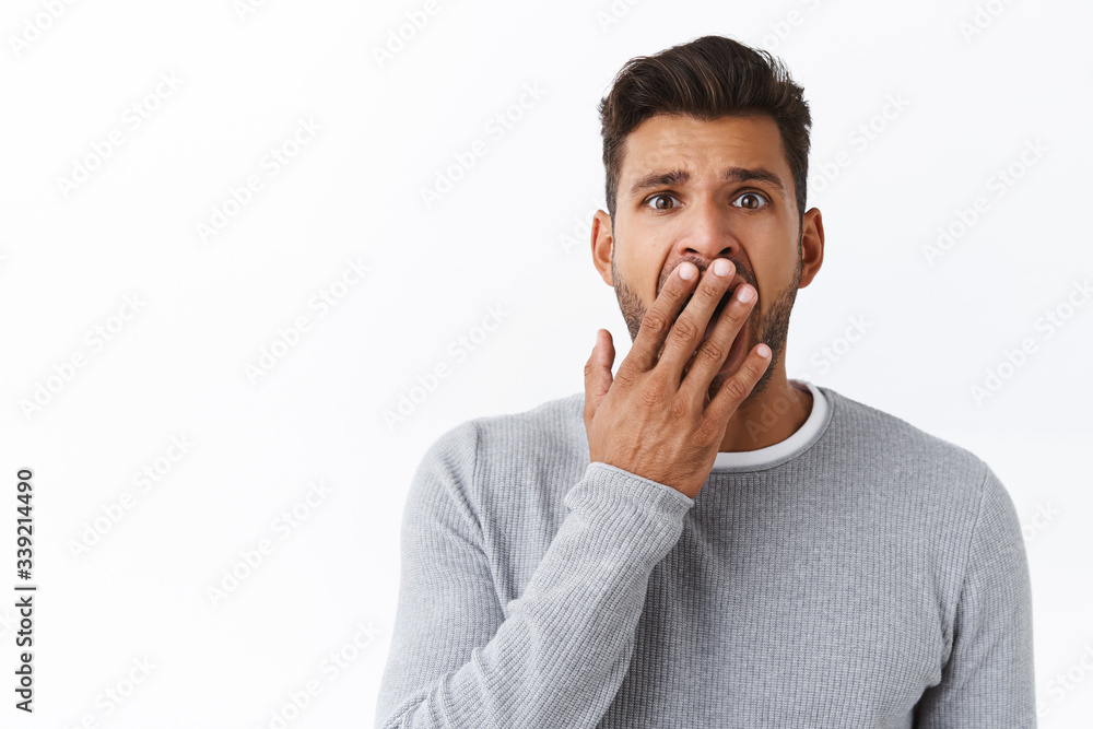 Bored guy trying look interested, open mouth wide and cover it with palm while yawning, look sorry or indifferent, have no interest in conversation, standing reluctant and sleepy, boredom concept Bored guy trying look interested, open mouth wide and cover it with palm while yawning, look sorry or indifferent, have no interest in conversation, standing reluctant and sleepy, boredom concept