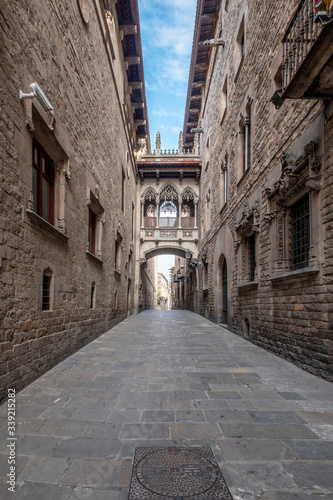 Fototapeta Naklejka Na Ścianę i Meble -  Barcelona, Catalonia / Spain: 04 09 2020: empty streets in the Bisbe street, in the Gothic Quarter in the city of Barcelona during the covid-19 coronavirus pandemic