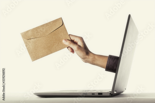 Murais de parede The human hand with envelope stick out of a laptop screen