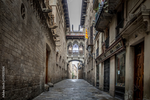 Barcelona, Catalonia / Spain: 04 09 2020: empty streets in the Bisbe street, in the Gothic Quarter in the city of Barcelona during the covid-19 coronavirus pandemic © ikuday