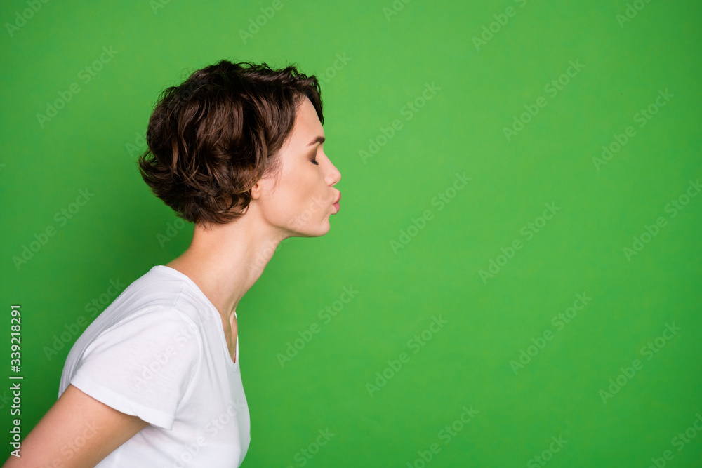 Profile photo of attractive cute lady wavy bobbed hairdo sending air kisses empty space flirty eyes closed wear casual white t-shirt isolated bright green color background Profile photo of attractive cute lady wavy bobbed hairdo sending air kisses empty space flirty eyes closed wear casual white t-shirt isolated bright green color background
