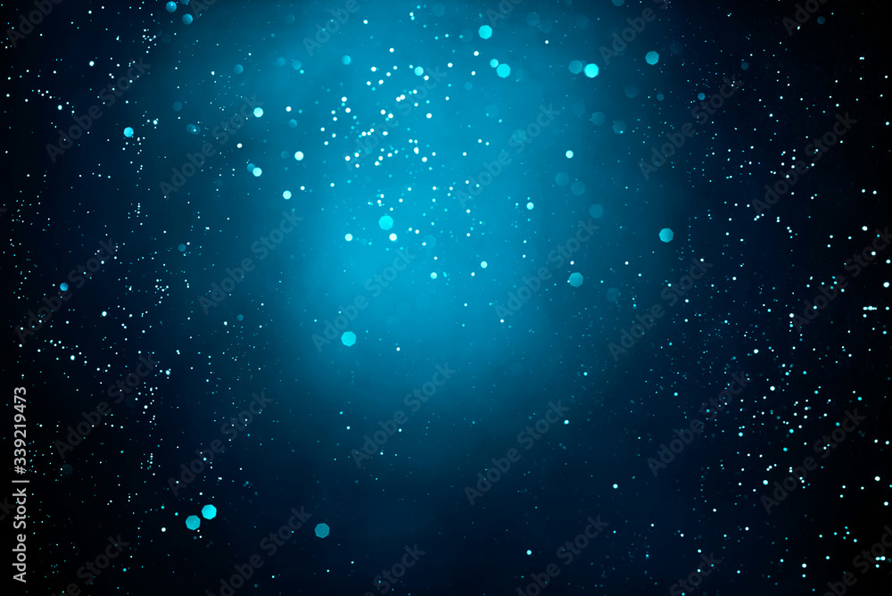 Abstract dark background with glowing turquoise particles.