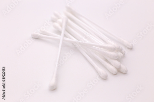 Lots of cotton swabs on a white background