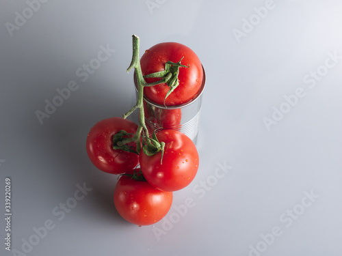 top view of some red tomatoes on a tin, canned food concept © Novodiastock