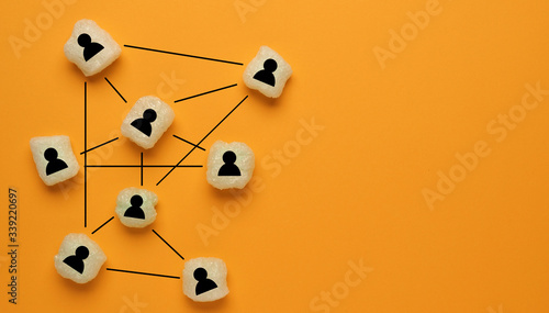 Abstract teamwork, network and community concept on orange