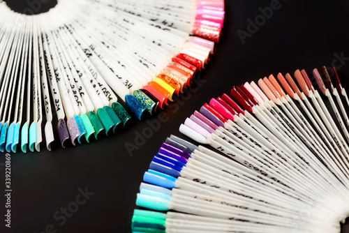 A palette of nails polish for professional manicures on a dark background