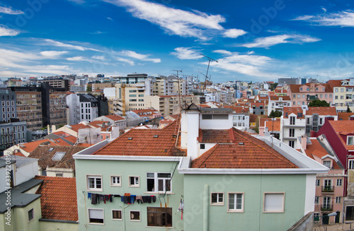 High angle view on traditional houses and apartment buildings with orange tiled roofs in the city of Lisbon, 