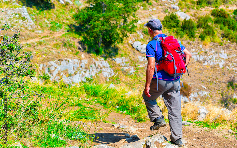 Man with backpack on Path of Gods reflex Man with backpack on Path of Gods reflex