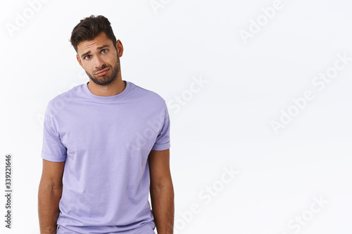 Cute and silly charming boyfriend looking gloomy at girlfriend complaining tough day, sulking and gazing with condole or compassion, feeling empathy person having bad day, standing white background