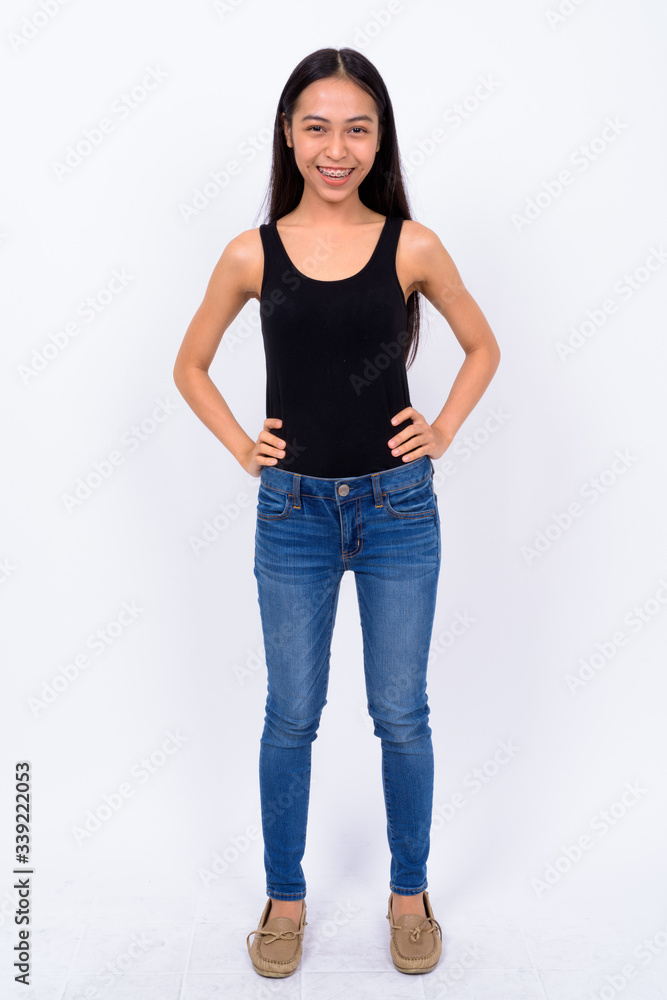 Full body shot of happy young beautiful Asian woman smiling Full body shot of happy young beautiful Asian woman smiling