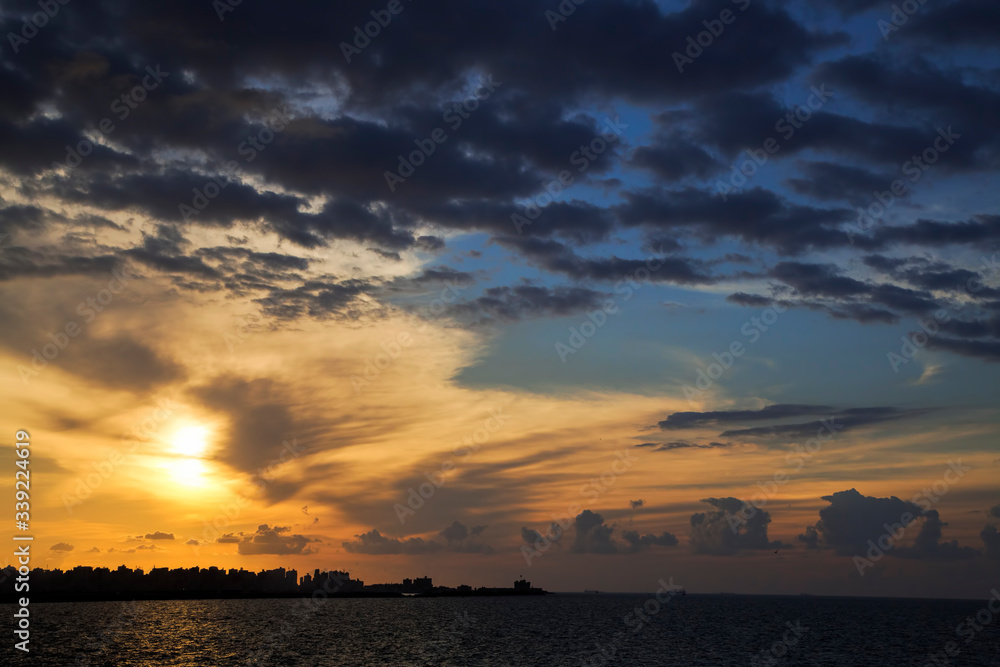 Silhouette of coast with cloudy sky in twilight Silhouette of coast with cloudy sky in twilight