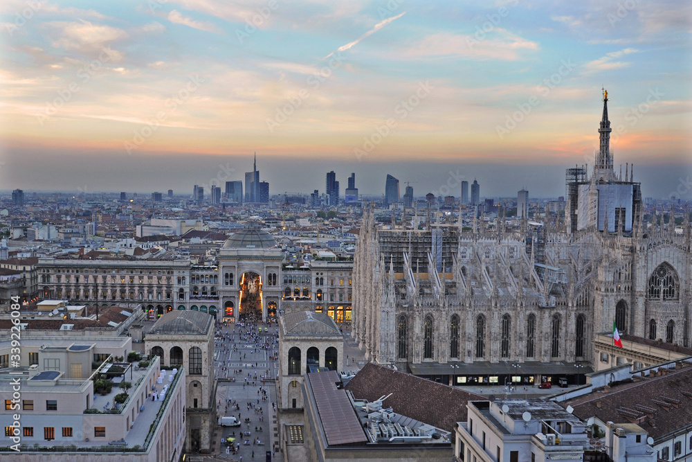 Italy - Milan march 19,2020 - Vittorio Emanuel Gallery, Duomo Cathedral and skyline with mountains - City life and downtown , aerial view 