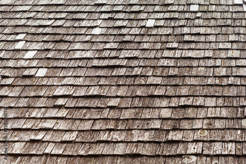 background, the roof of the old house of the house is covered with wooden tiles