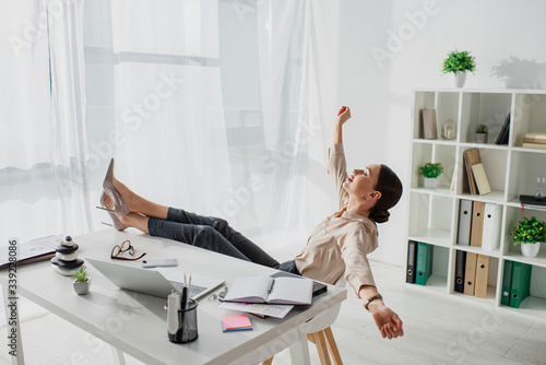 Schilderij op canvas young businesswoman procrastinating at workplace in office