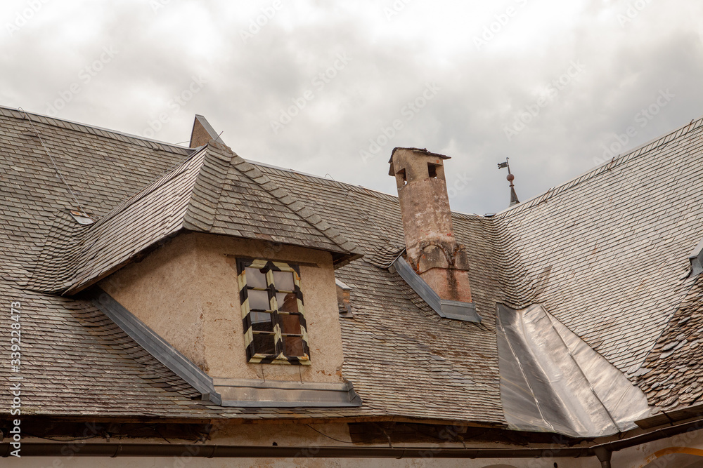 the roof is covered with shingles with chimney, Palace Hochosterwitz, Austria