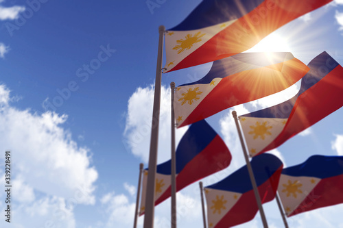 Philippines flags waving in the wind against a blue sky. 3D Rendering