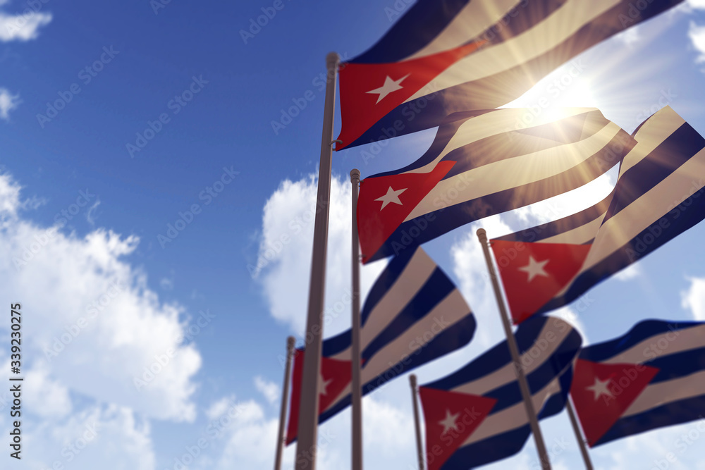 Cuba flags waving in the wind against a blue sky. 3D Rendering