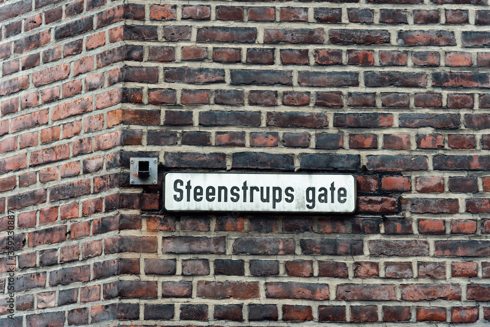 Street name sign on old brick wall in Oslo. Steenstrups gate