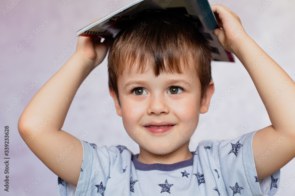 Little boy drawing with color pencils. Little boy is holding color pencils. Boy, drawing a picture for fathers day. Little boy drawing with color pencils. Little boy is holding color pencils. Boy, drawing a picture for fathers day.