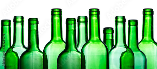 Green wine bottle. Empty glass isolated on white. Set of blank no label wine bottle in a row. Winery shelf texture. Alcohol background. Shiny transparent vibrant color panoramic view.