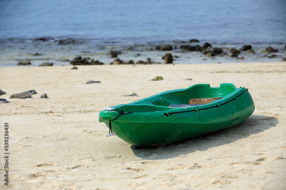 Small and green boat on sand at seabeach Small and green boat on sand at seabeach