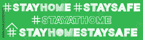 hashtag stay home, stay safe text hand lettering with bold white chalk font on green school board background, stock vector illustration clip art header photo