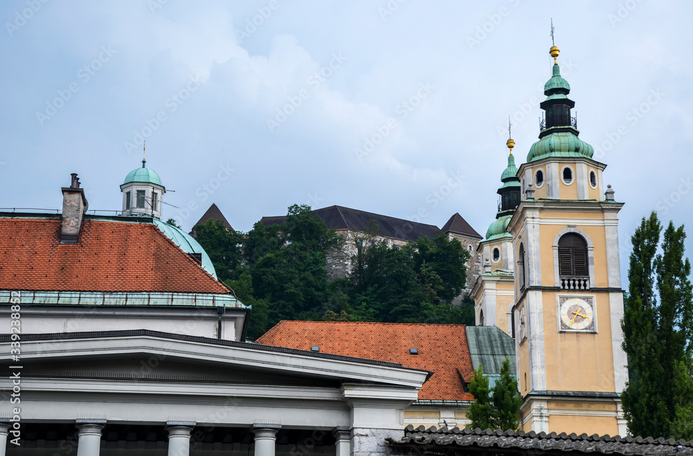 Beautiful view to the roofs of the Buildings  with the Saint Nicholas Cathedral towers and  castle in Ljubljana, which is located in the center of the capital of Slovenia